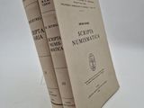 three books are stacked on top of each other on a white surface