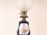 a lamp that is sitting on a table next to a white wall