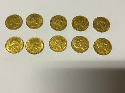 a group of gold coins sitting on top of a white table