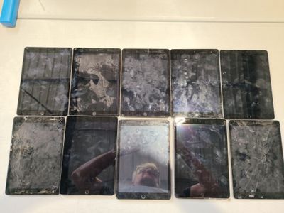 a picture of a man taking a selfie in front of a bunch of cell phones