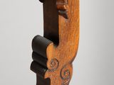 a close up of a wooden sculpture of a man ' s face