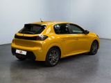 the rear end of a yellow car parked in a room