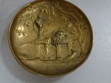 an image of a gold plate with a lion and a bird on it