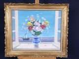 a painting of flowers in a vase on a easel