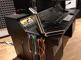 an image of a recording studio with multiple monitors and a laptop