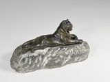bronze statue of a lion on a rock on a white background