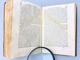 a magnifying glass sitting on top of an open book