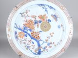 a plate with flowers and birds painted on it