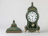 a small green clock sitting next to a smaller green clock