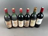 six bottles of wine lined up in a row on a table