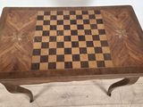 a wooden table with a chess board on top of it