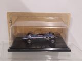 a small blue car in a clear box on a table