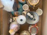 a cardboard box filled with assorted vases and other decorative items
