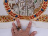a hand that is pointing at a picture of a castle