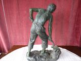 a statue of a man with a hammer on a table