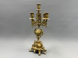 an image of a brass candelier with five candles
