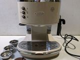 a coffee machine sitting on a table with a cup of coffee