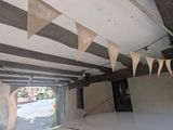 flags hanging from the ceiling of a building in a garage