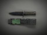 a knife that is laying on top of a piece of metal