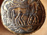 a close up of a coin with a horse and a man on it
