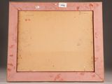 an old pink picture frame sitting on top of a white table