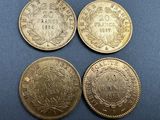 three gold coins, one of which is a sovereign and one of which is a sovereign