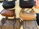 a lot of purses that are on a table
