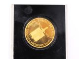 a close up of a gold coin on a black surface