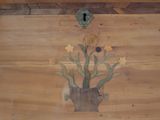 a picture of a wooden box with a flower design on it