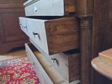 a wooden dresser with four drawers in a room