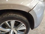 a close up of a car ' s tire on the side of the road