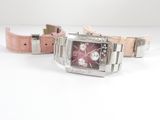 a watch that is sitting on a table with a pink strap