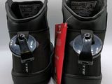 pair of black ski boots with a red tag on them