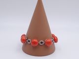 bracelet with red coral beads and silver beads on a cone