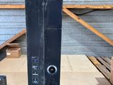 an image of a black computer on a wooden table