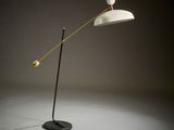 a black and white floor lamp with a white shade on it