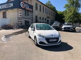 a small white car parked in front of a building