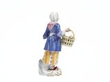 a figurine of a woman with a basket and a cat