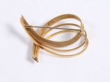 a gold brooch with a snake on top of it