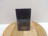 the bottle of christian love perfume is sitting on a wooden table