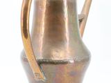a metal watering pot with a handle on a white background