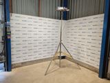 a camera on a tripod in front of a wall