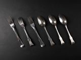 six forks and spoons are arranged in a row on a black surface