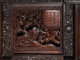 a wooden panel with carvings on it in a room