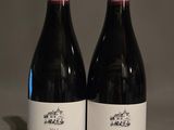 deux bouteilles de vin rouge posées l'une à côté de l'autre sur une table