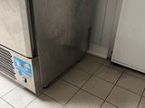 a microwave sitting on top of a refrigerator in a kitchen