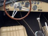 dashboard of a classic car with a steering wheel and dashboard controls