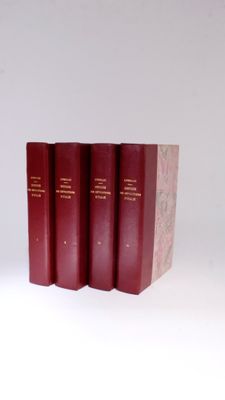 three red books sitting on top of each other on a white surface