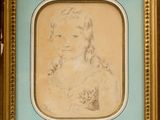 an old picture of a young girl holding a cat in a gold frame