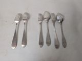 six forks and spoons sitting on top of a white table